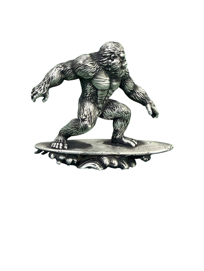 Hand-poured .999 fine silver Big Foot Hang 10 statue by Tormint, Sasquatch riding a surfboard on a cresting wave, front view